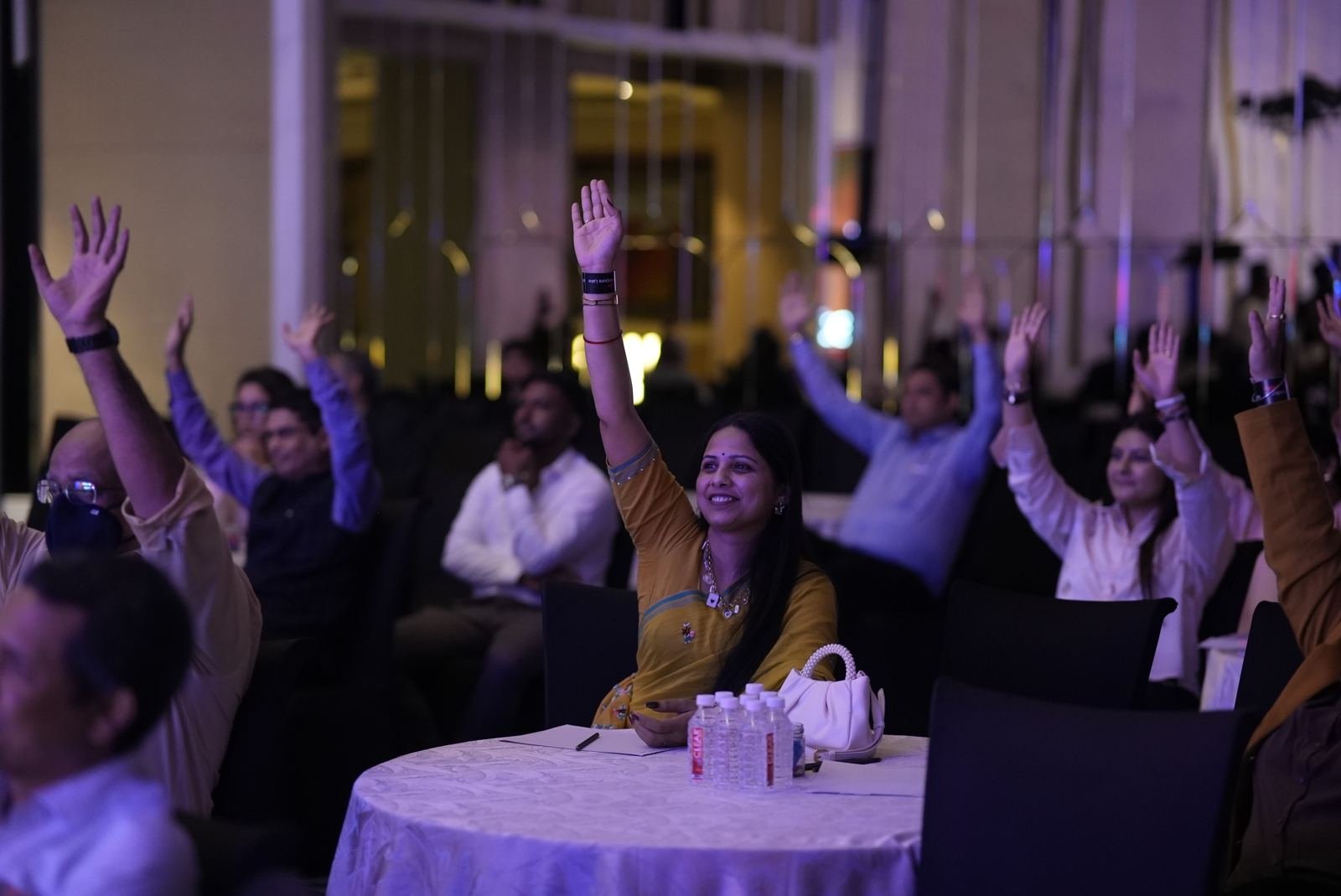 Audience raising their hands during a session