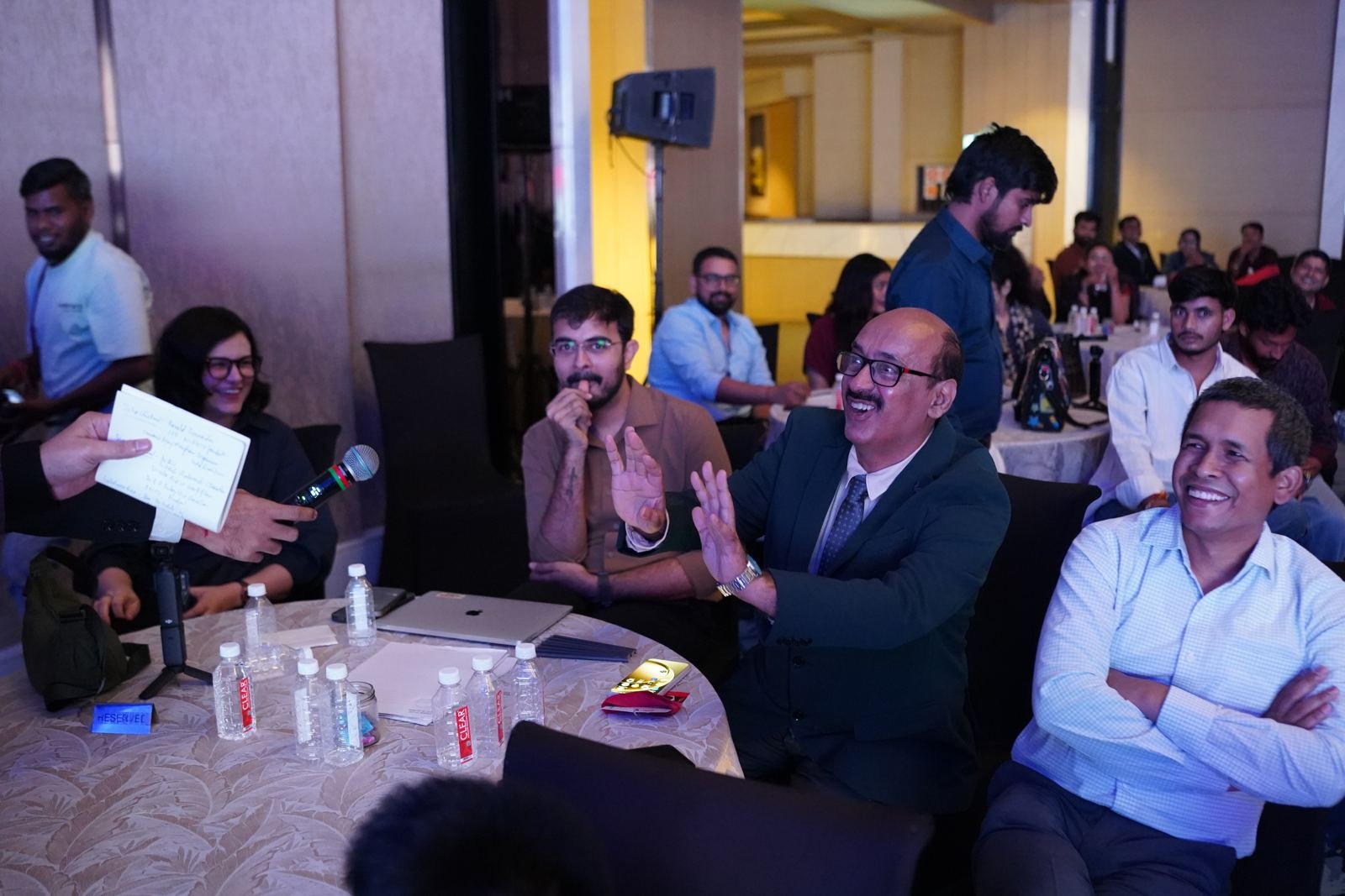 Attendees sharing a laugh during an audience interaction