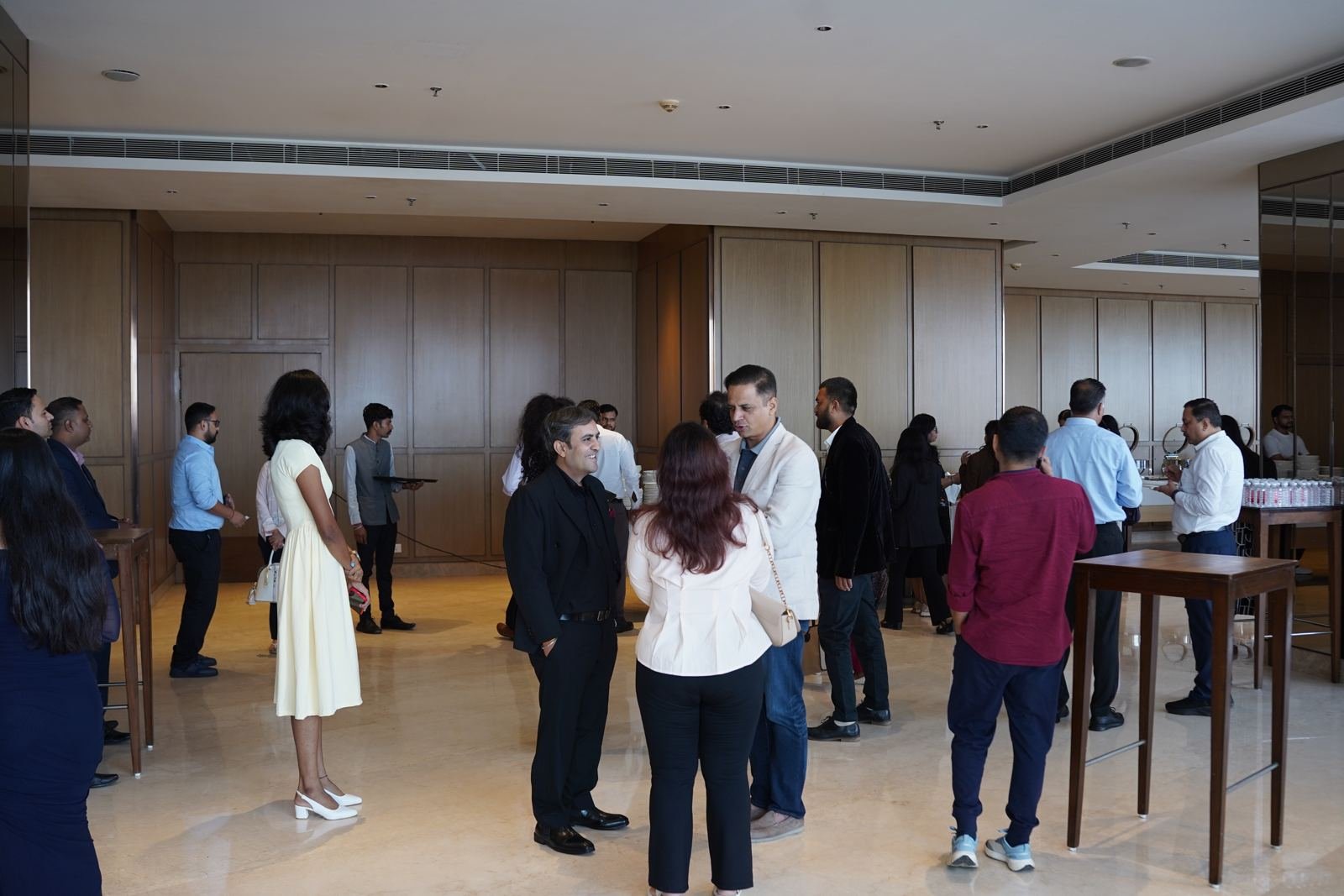 Attendees mingling in the foyer during the break