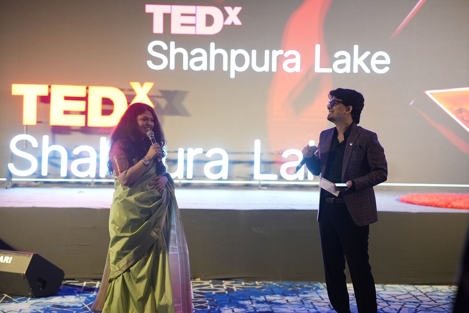 The hosts welcoming the audience on stage