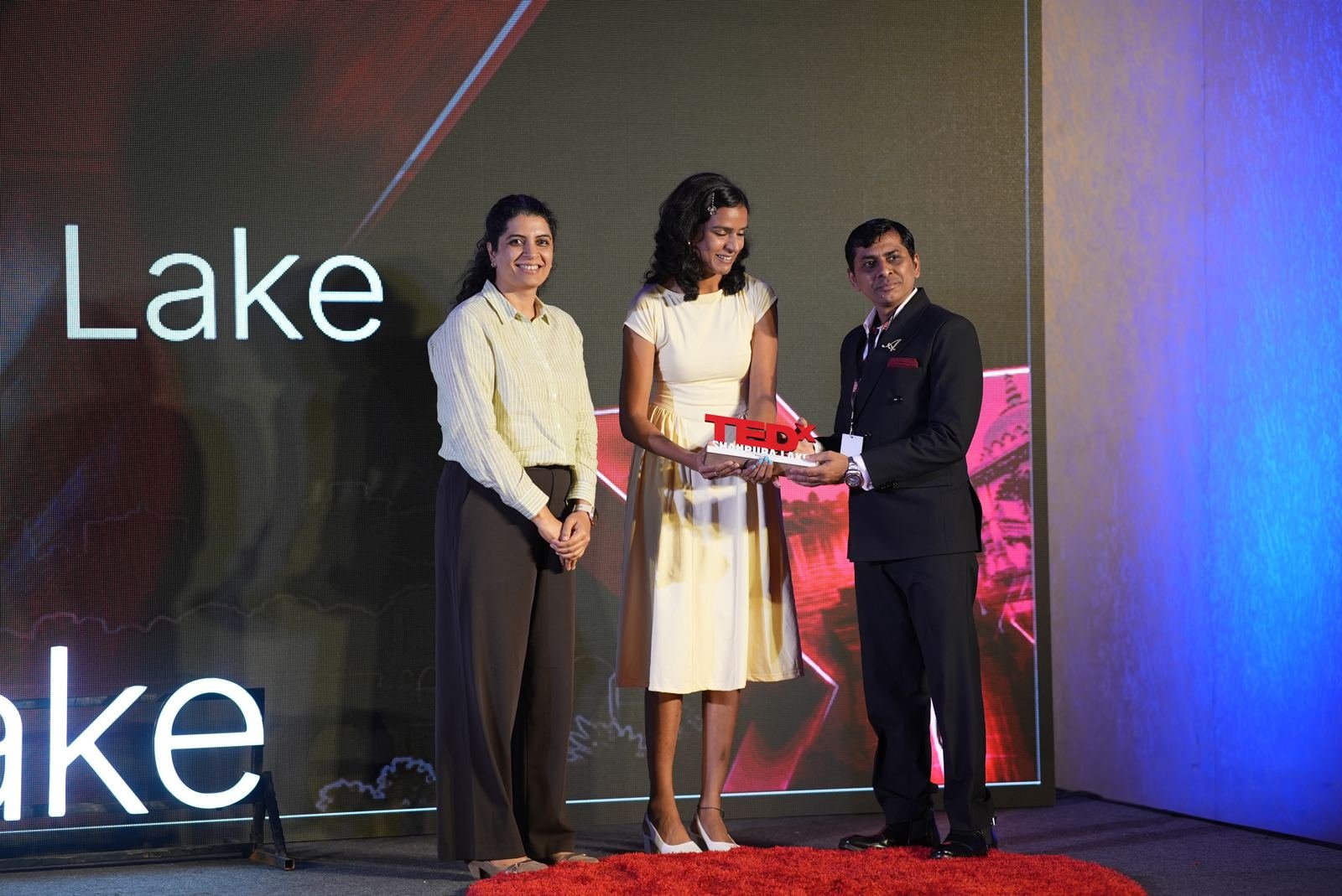 A speaker being felicitated after her talk
