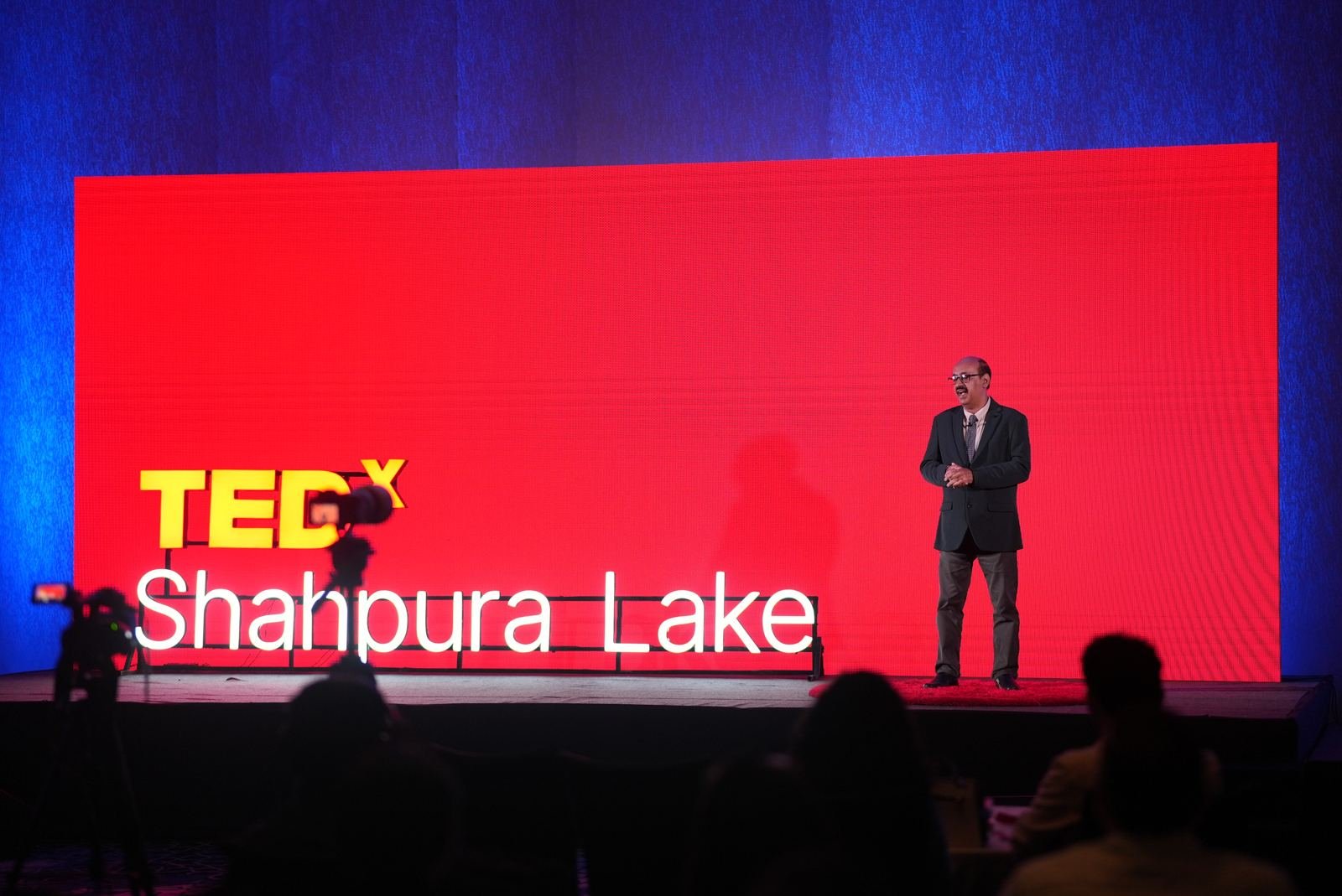 The TEDxShahpura Lake 2026 stage with the audience in the foreground