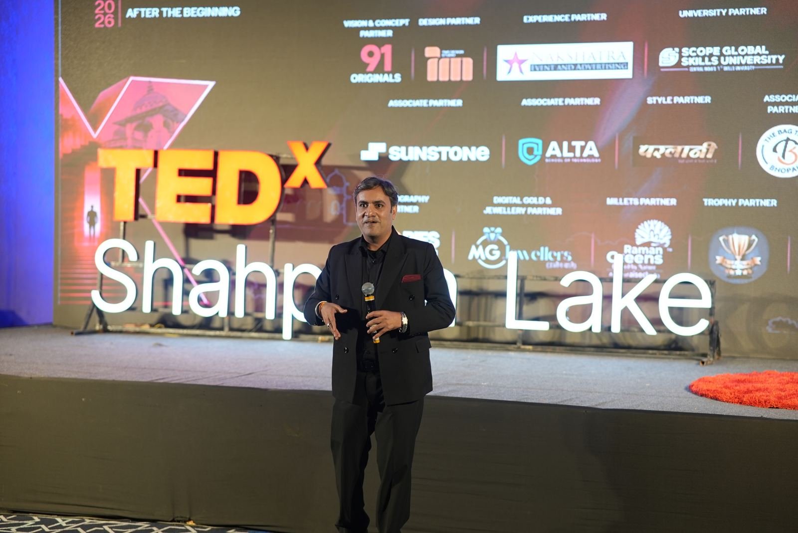 Performer on stage in front of the partner wall